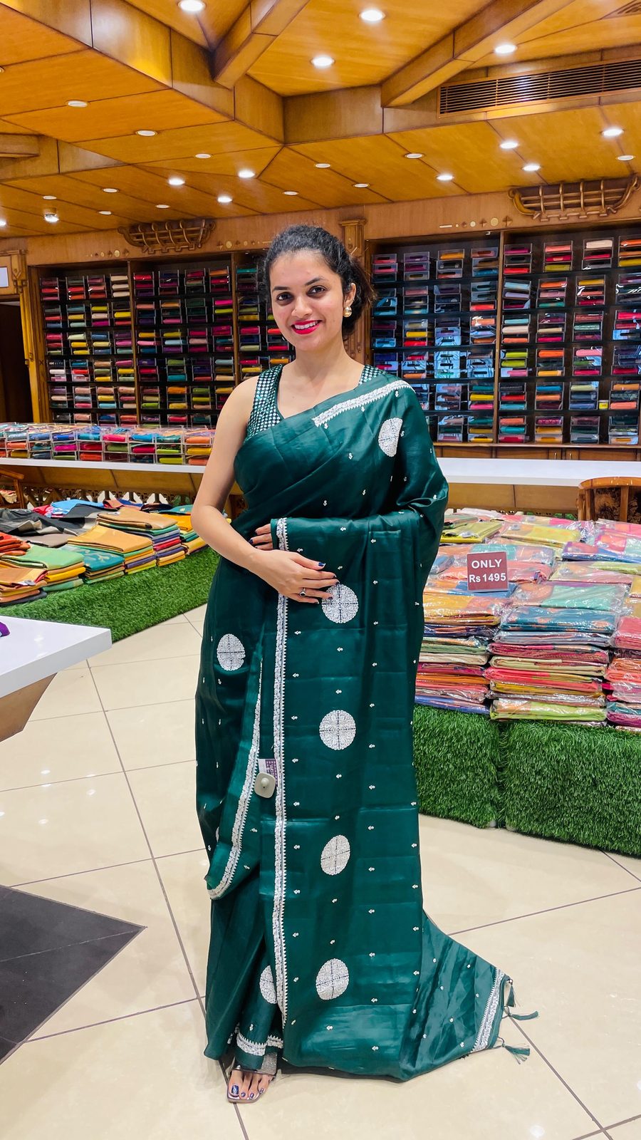Model in a soft cotton saree with floral print standing inside the Shasthas store