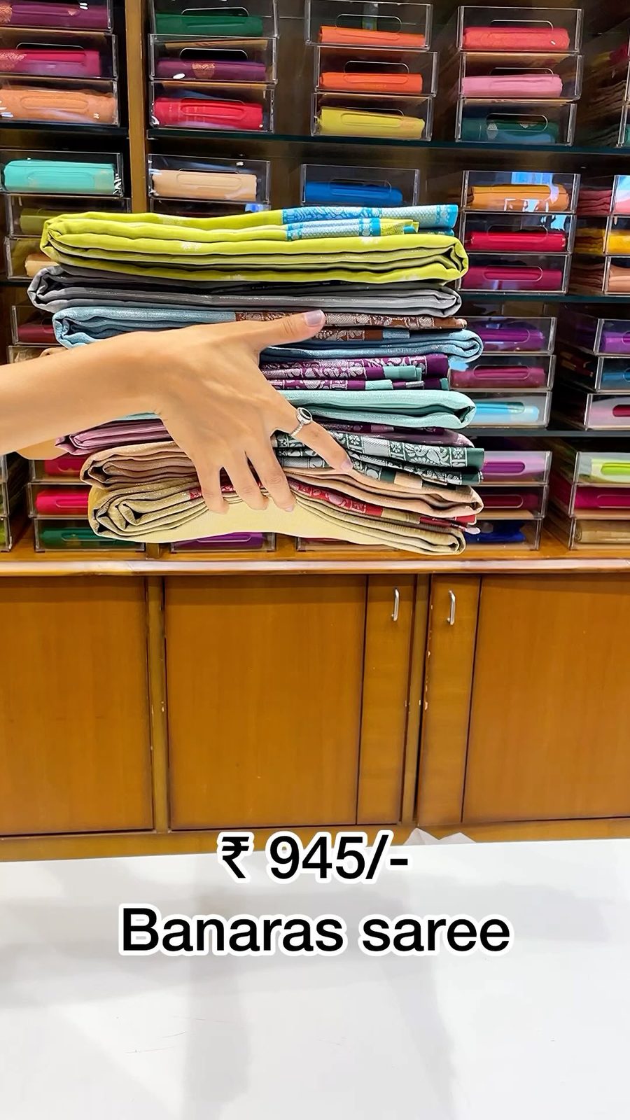 Model wearing an emerald crape silk saree with silver border inside the Shasthas store