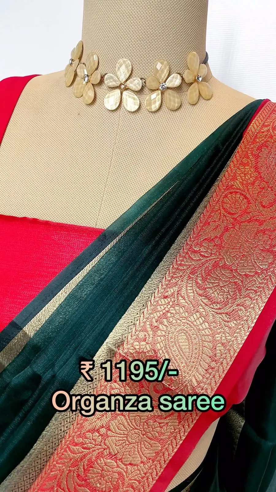 Mannequin displaying a rose-pink organza saree with antique zari border