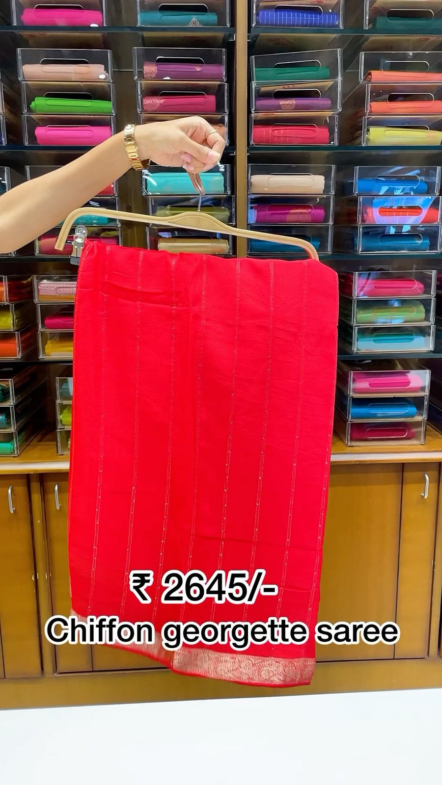 Model in a deep crimson tissue grand saree with full pallu display